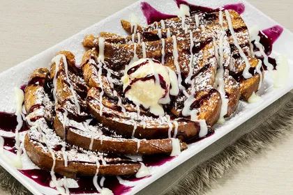 Crunchberry French Toast — Texas toast rolled in Crunchberry cereal with blueberry jelly, cream cheese icing and powdered sugar
